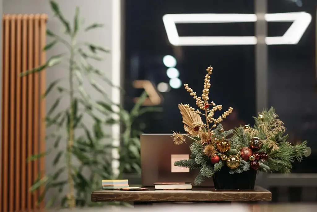 Wood Element for Career Growth - 猫哥风水|马来西亚风水・紫微斗数・奇门遁甲 A workspace desk with a laptop and decorative plants, representing the Wood element for career expansion.